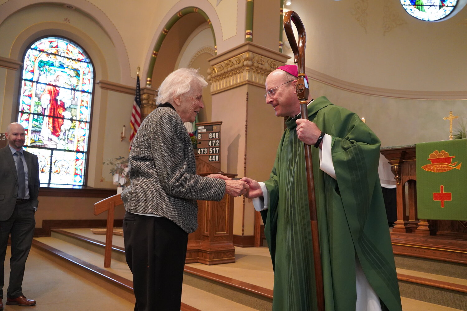 Bishop W. Shawn McKnight presents the Missouri Catholic Conference’s 2023 Citizen Recognition Award for the Jefferson City diocese to Jean Wankum, who has been volunteering for Birthright of Mid-Missouri for 50 years, at Mass on Nov. 19 in Immaculate Conception Church in Jefferson City.